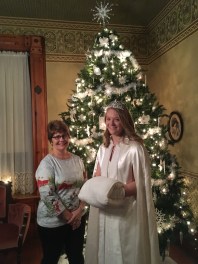 Sue Hurd VanAmburg poses with Snow Princess in front of Parlor's tree